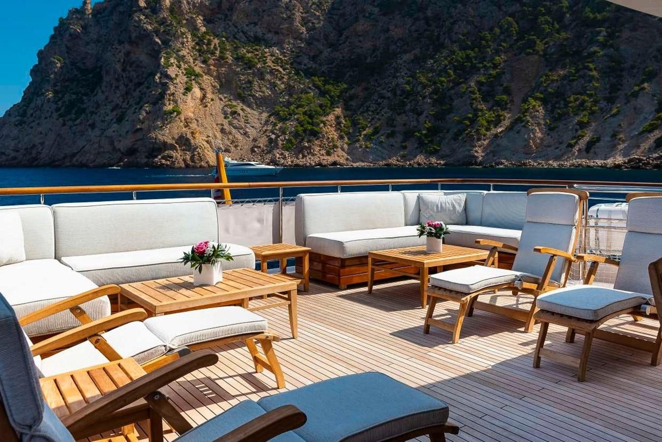 a room with tables and chairs aboard 2011 SANLORENZO SD92 FLYBRIDGE Yacht for Sale
