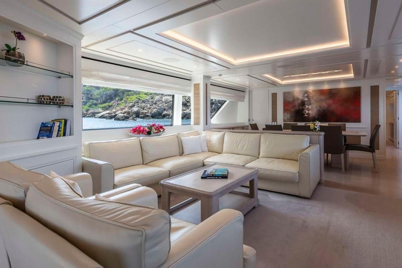 a living room with a couch and a table aboard 2011 SANLORENZO SD92 FLYBRIDGE Yacht for Sale