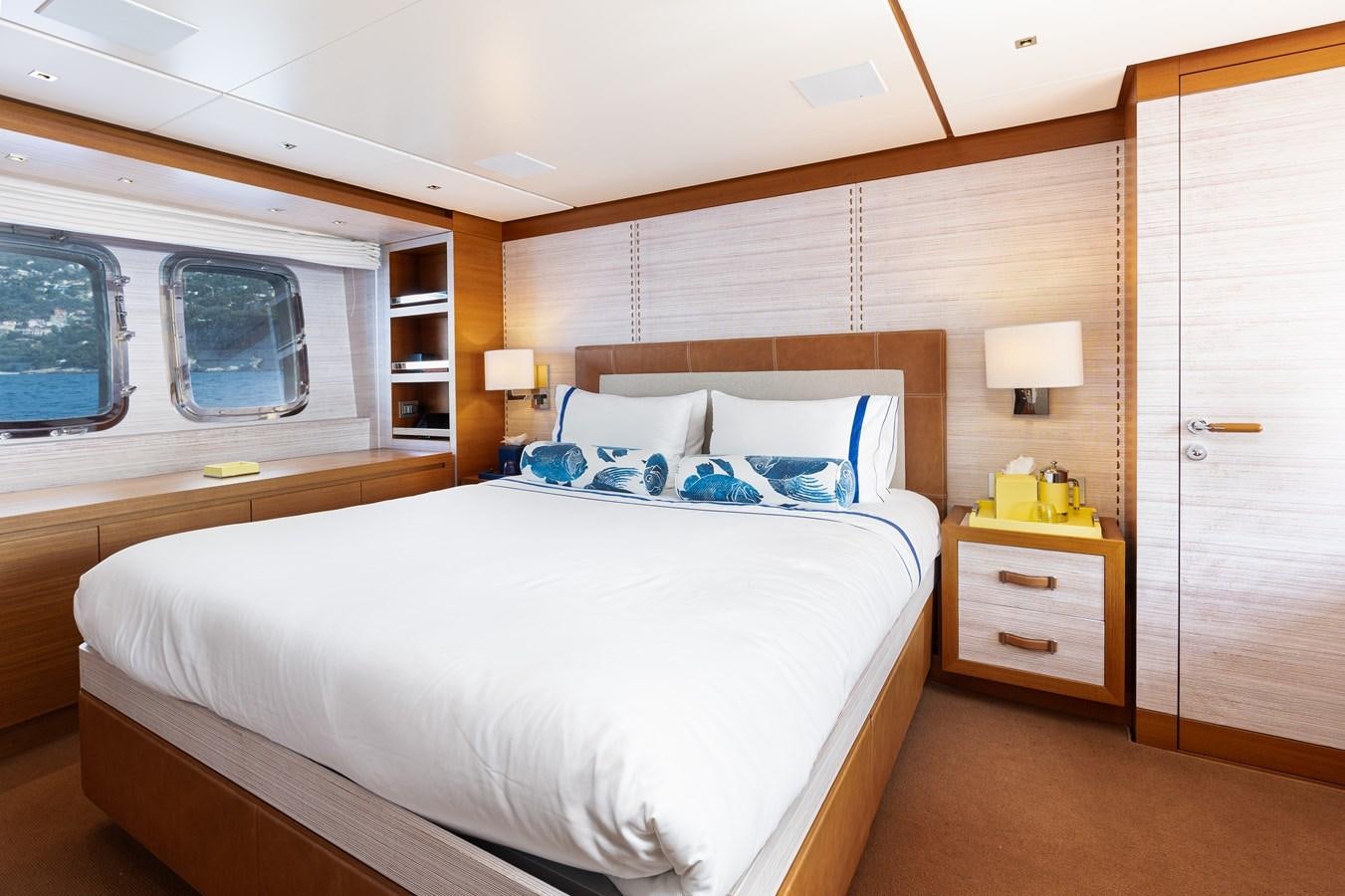a room with a bed and a window aboard THE GREAT ESCAPE Yacht for Sale