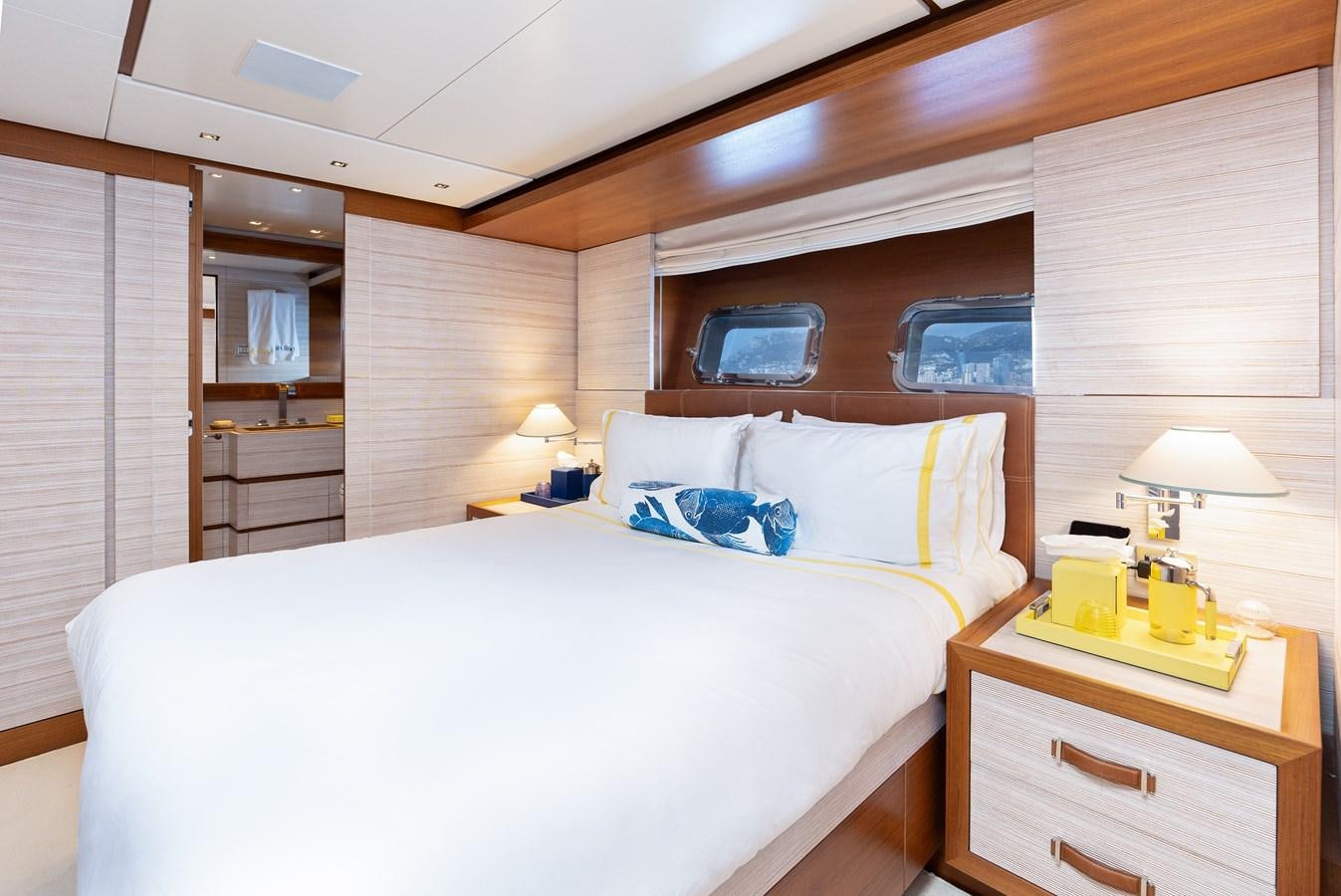 a bedroom with a bed and a desk aboard THE GREAT ESCAPE Yacht for Sale