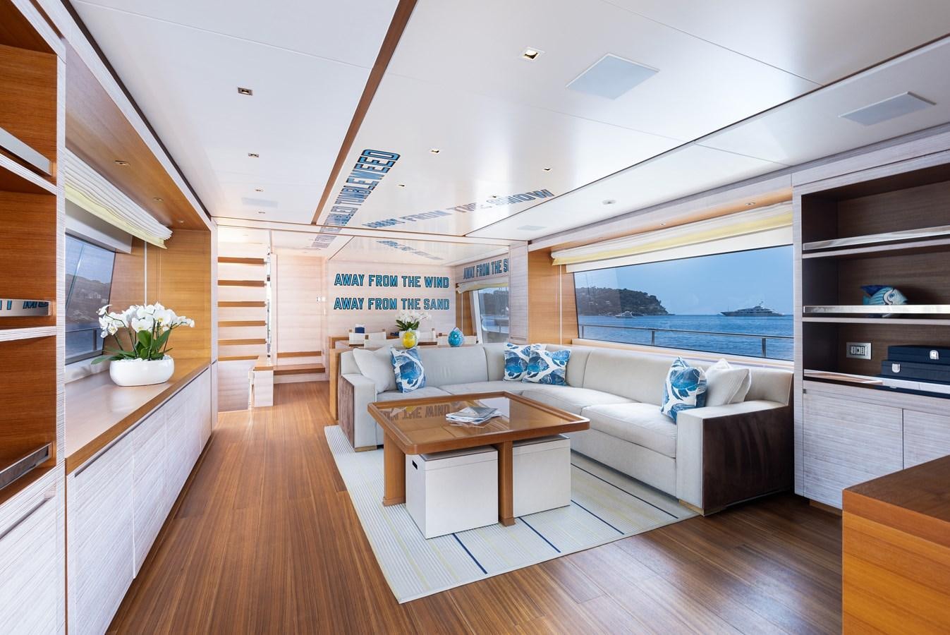 a living room with a large window aboard THE GREAT ESCAPE Yacht for Sale