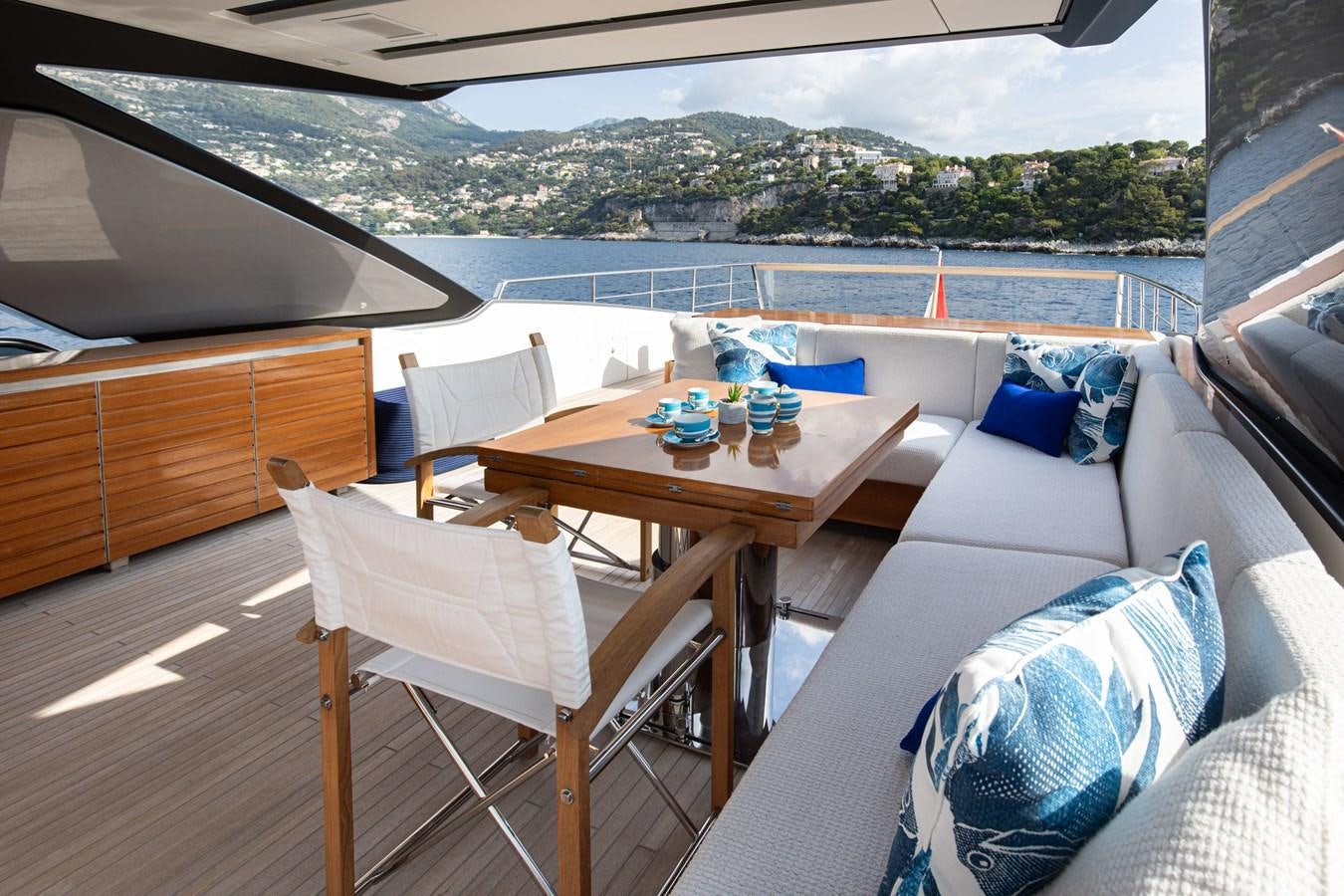 a table and chairs on a deck aboard THE GREAT ESCAPE Yacht for Sale