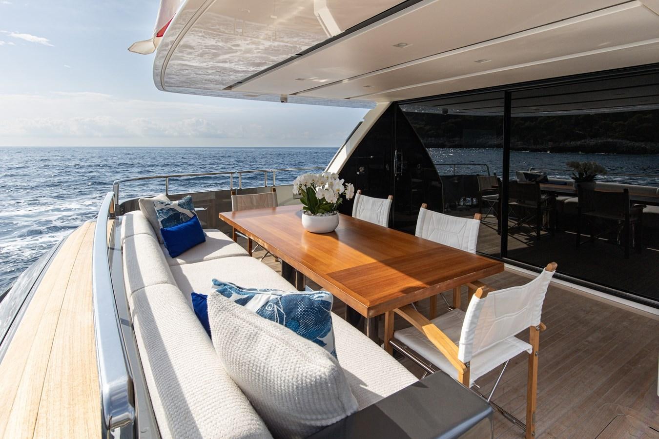 a table and chairs on a deck aboard THE GREAT ESCAPE Yacht for Sale