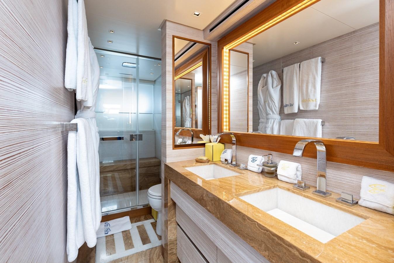 a bathroom with a glass shower aboard THE GREAT ESCAPE Yacht for Sale