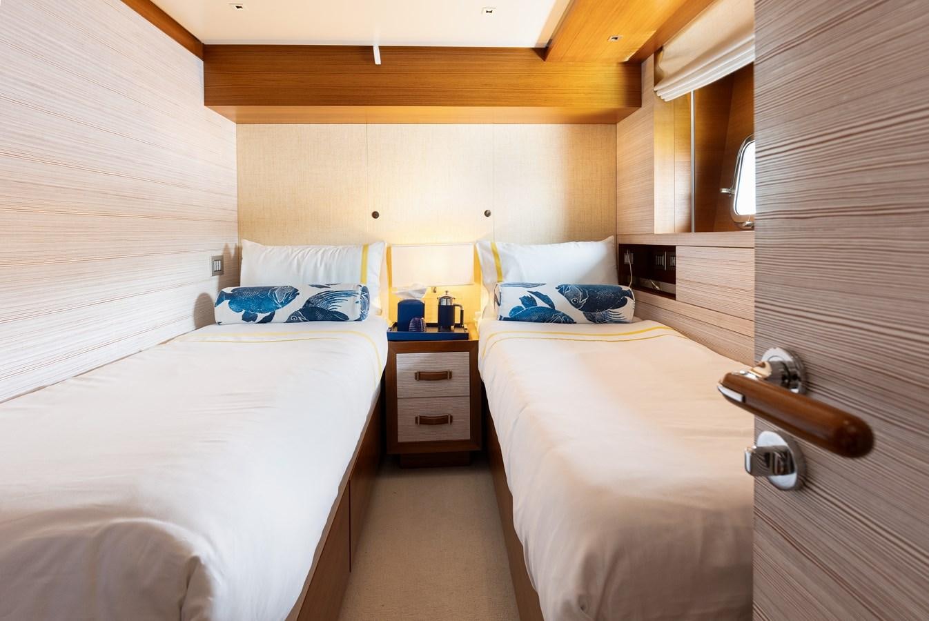 a room with beds and a dresser aboard THE GREAT ESCAPE Yacht for Sale