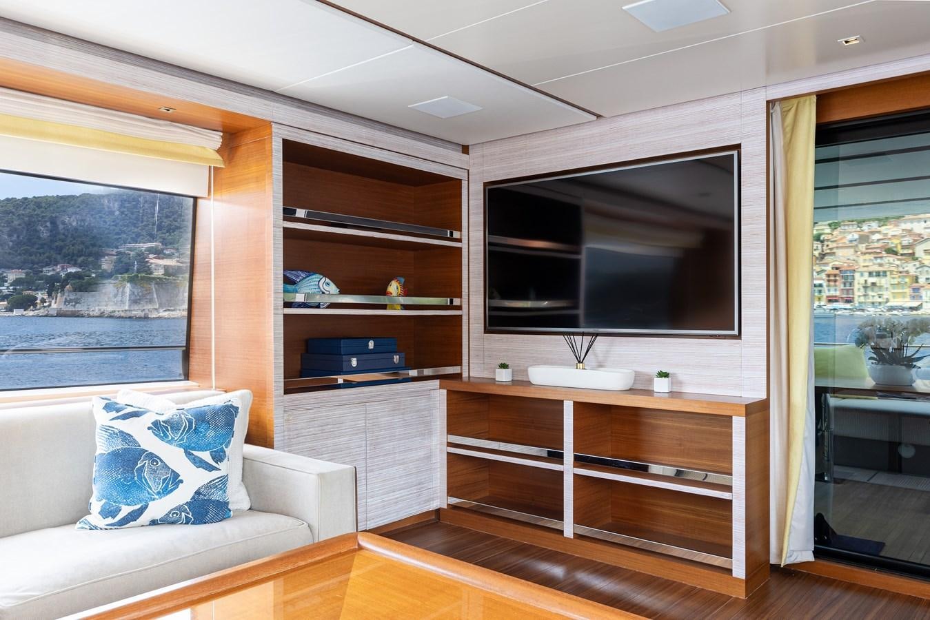a living room with a large television aboard THE GREAT ESCAPE Yacht for Sale