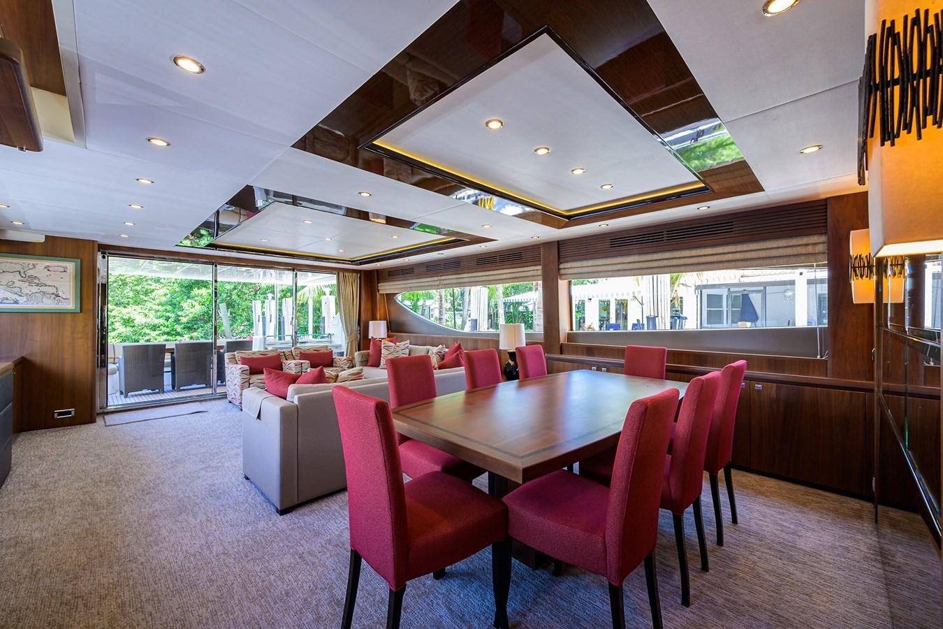 a large dining room with pink chairs aboard FREUDIAN SLIP Yacht for Sale
