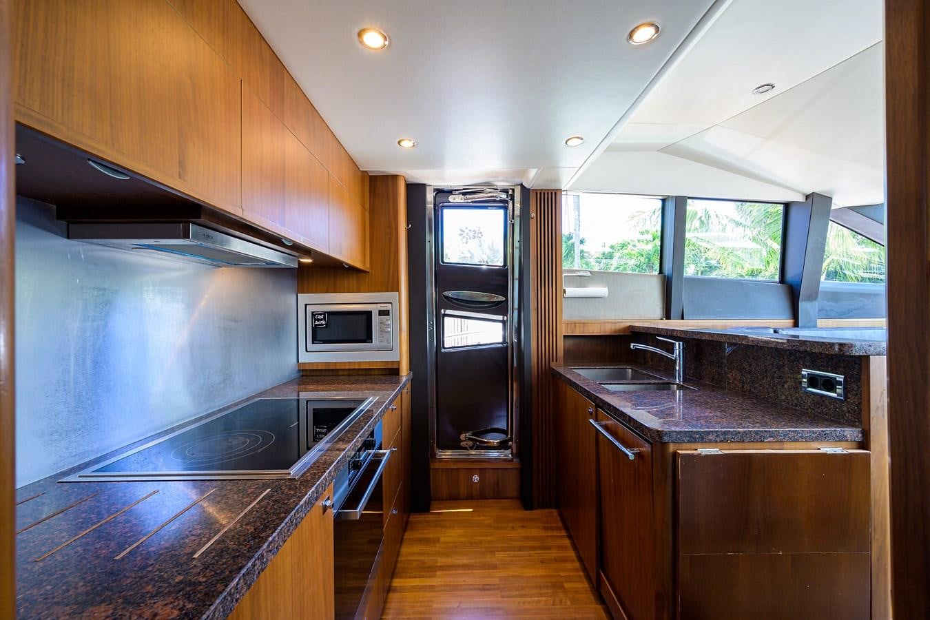 a kitchen with a large island aboard FREUDIAN SLIP Yacht for Sale