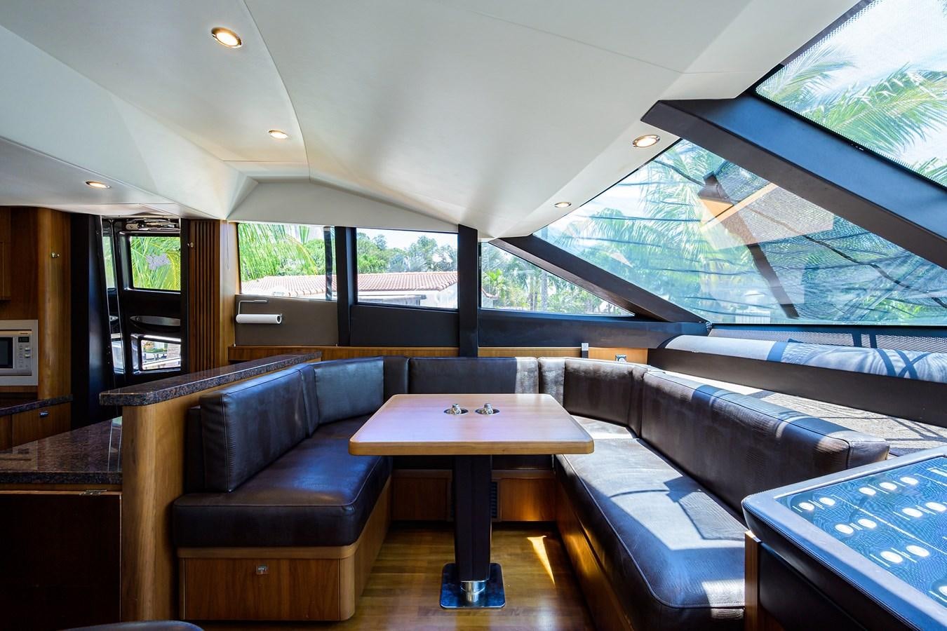 inside of a vehicle with a table and chairs and a couch aboard FREUDIAN SLIP Yacht for Sale