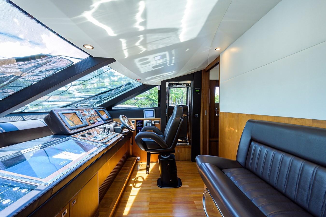 a room with a couch and a table with a laptop on it aboard FREUDIAN SLIP Yacht for Sale