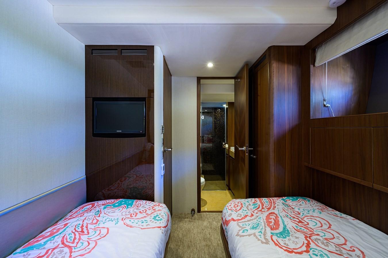 a bedroom with a bed and a tv aboard FREUDIAN SLIP Yacht for Sale