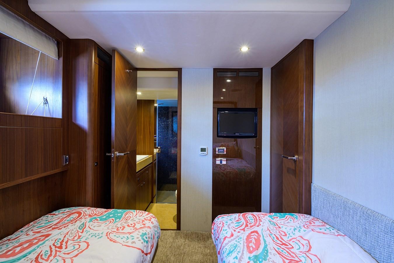 a bedroom with a bed and a television aboard FREUDIAN SLIP Yacht for Sale