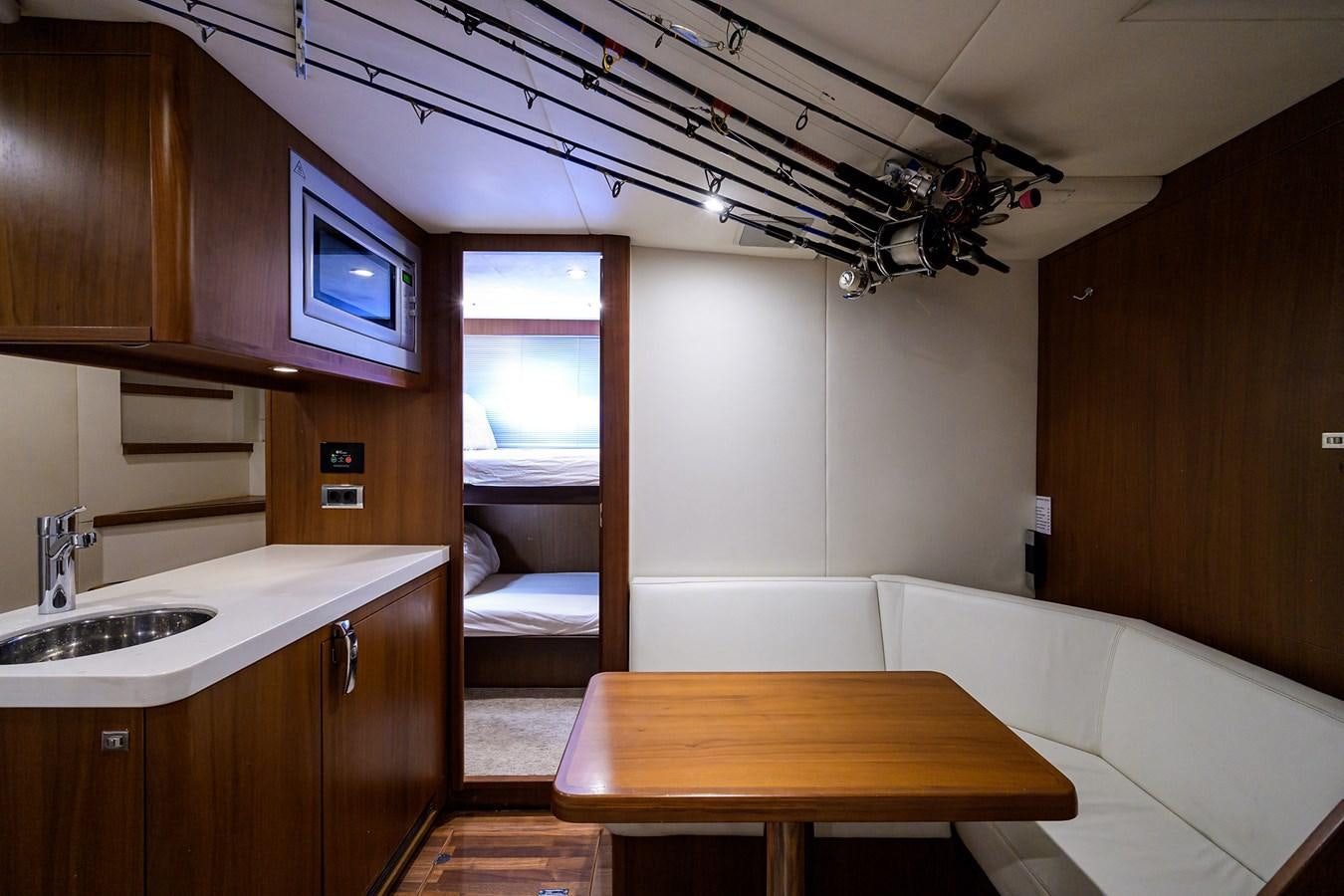 a small room with a bed and a table aboard FREUDIAN SLIP Yacht for Sale
