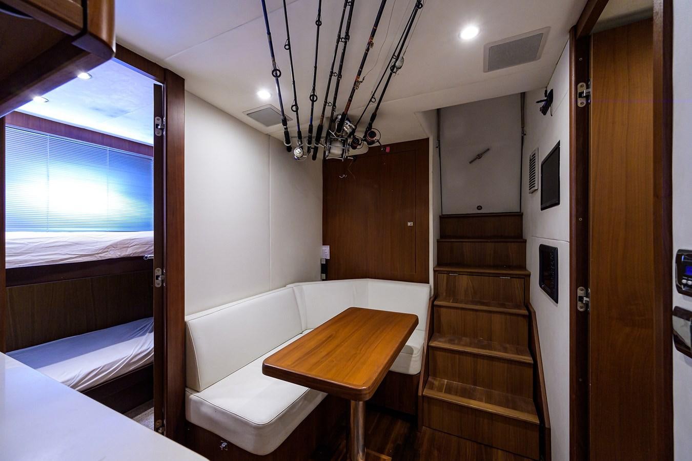 a room with a bed and a table aboard FREUDIAN SLIP Yacht for Sale