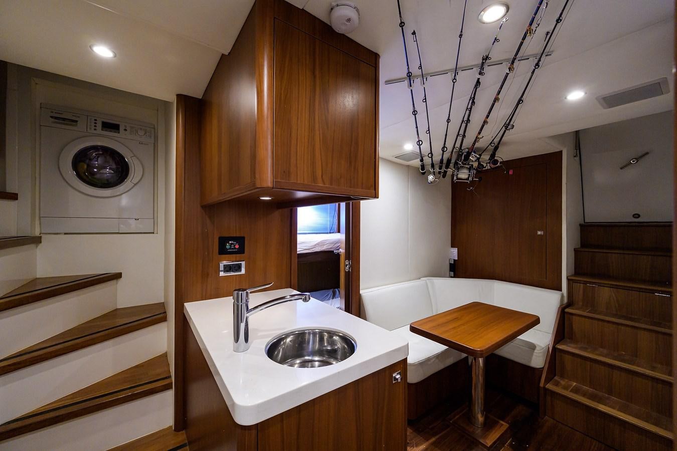 a kitchen with a sink and a mirror aboard FREUDIAN SLIP Yacht for Sale