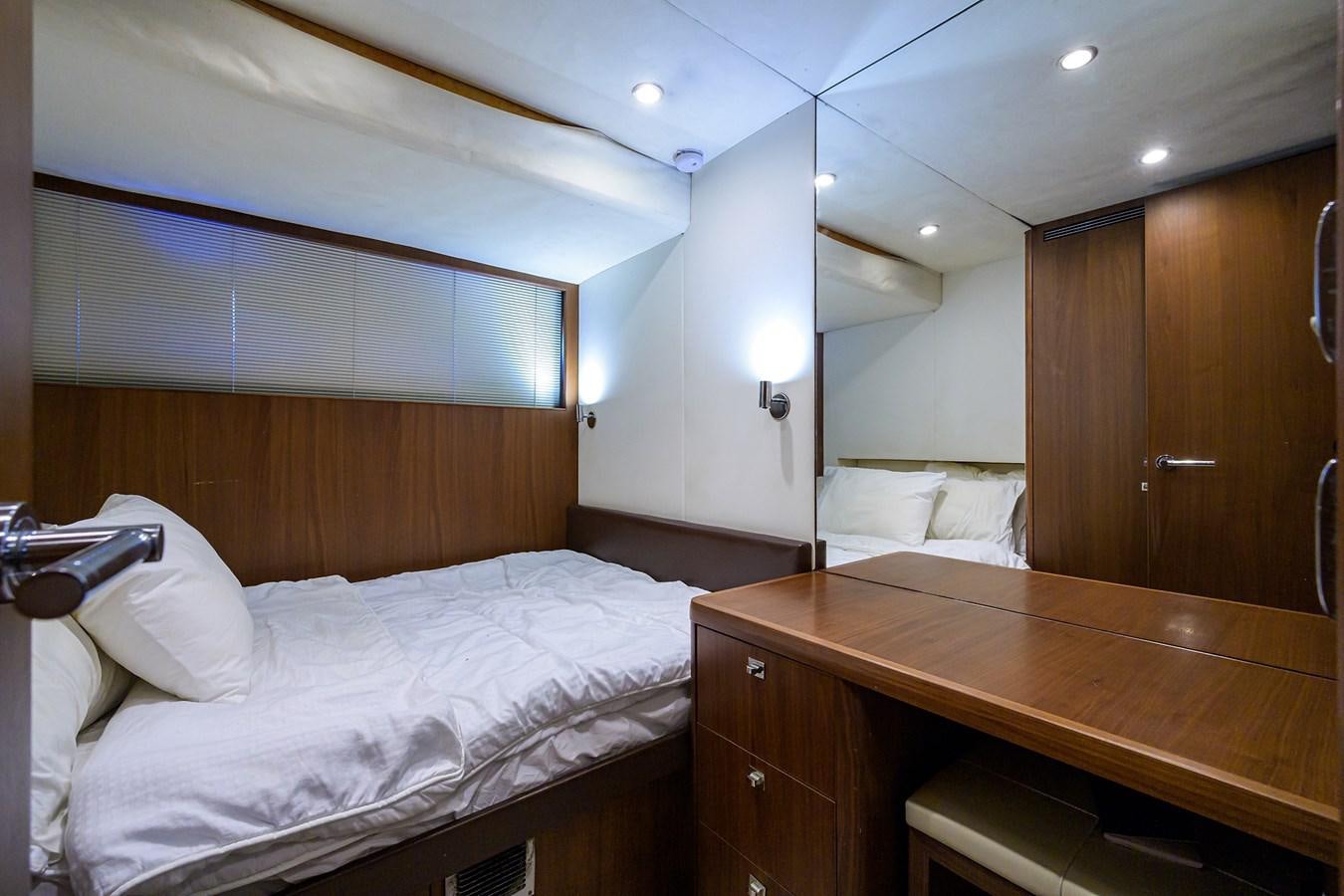 a room with a bed and a desk aboard FREUDIAN SLIP Yacht for Sale