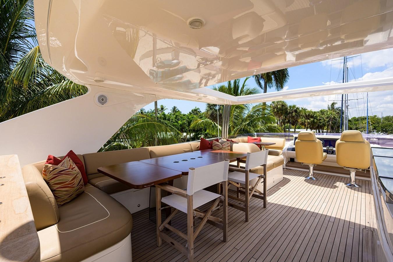 a lounge area with a table and chairs aboard FREUDIAN SLIP Yacht for Sale