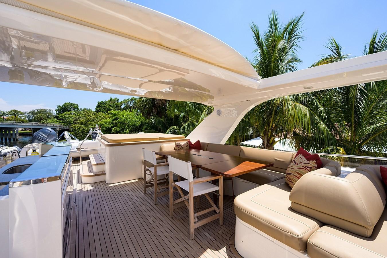 a deck with a large lounge chair and a large umbrella aboard FREUDIAN SLIP Yacht for Sale