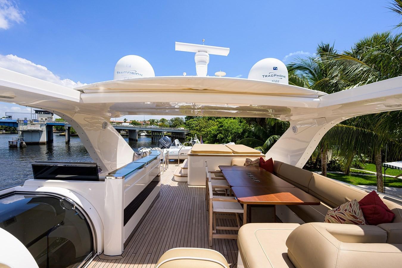 a deck with a pool and a building with a dome and palm trees aboard FREUDIAN SLIP Yacht for Sale