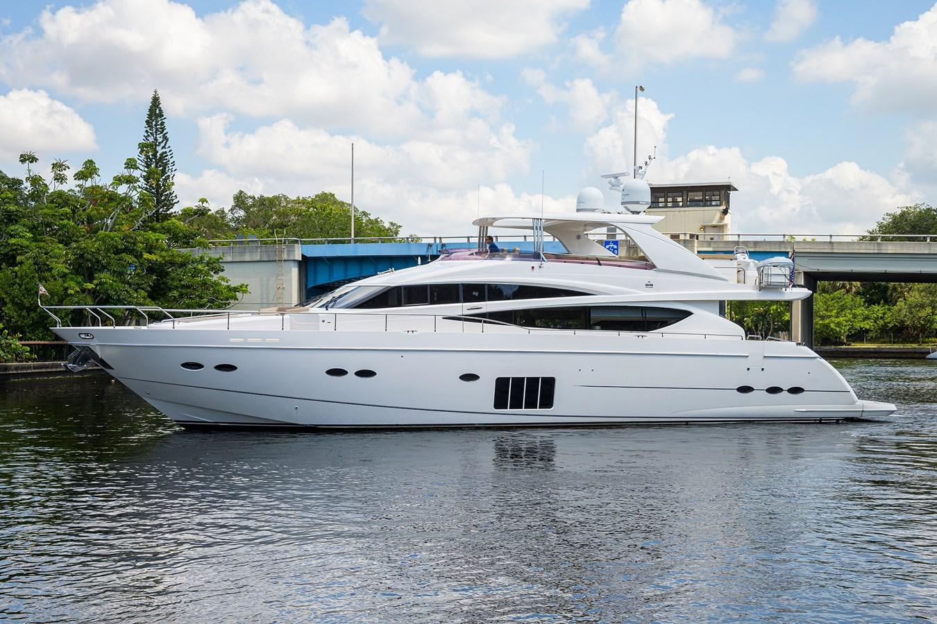a white yacht in a harbor aboard FREUDIAN SLIP Yacht for Sale