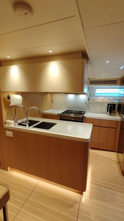 a kitchen with wooden cabinets aboard SULITA Yacht for Sale
