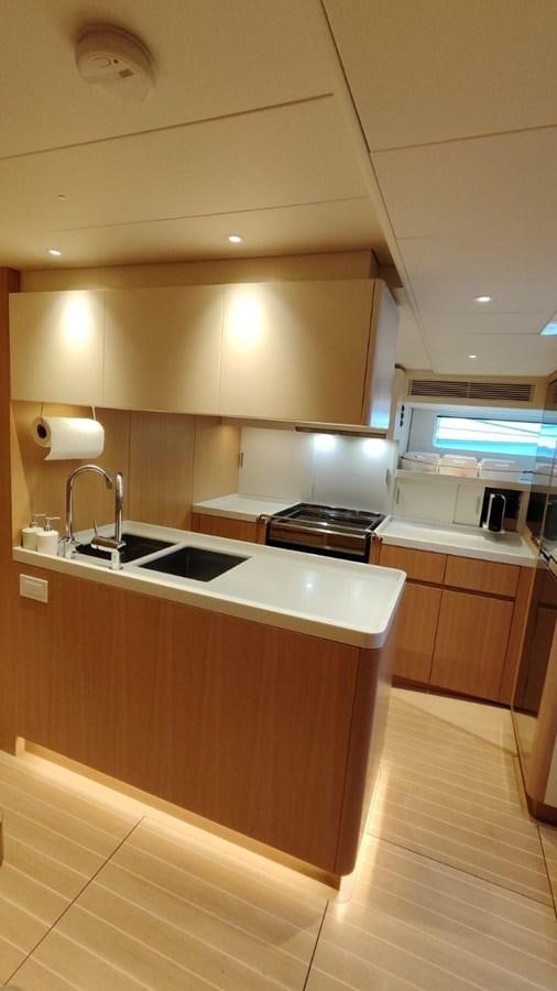 a kitchen with wooden cabinets aboard SULITA Yacht for Sale