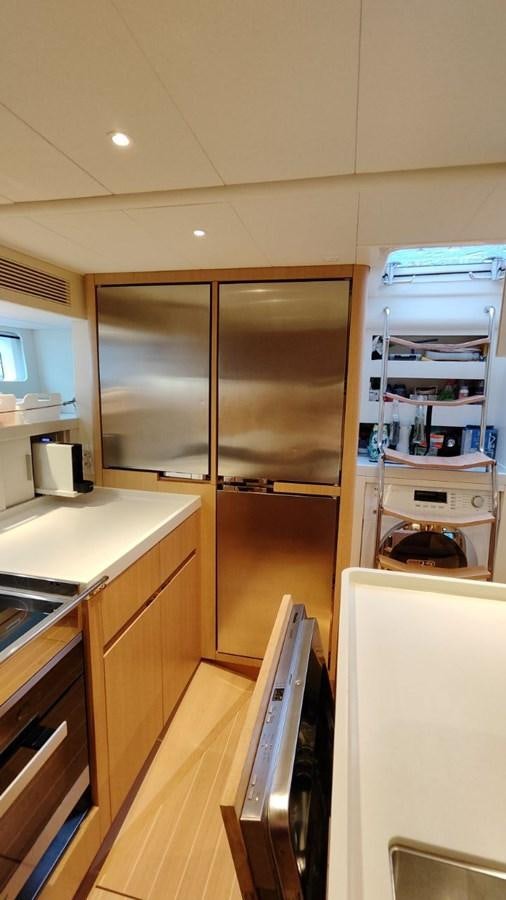 a kitchen with a stainless steel refrigerator aboard SULITA Yacht for Sale