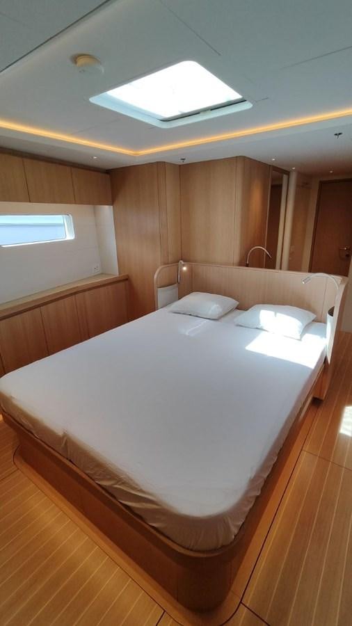 a bed with white sheets aboard SULITA Yacht for Sale