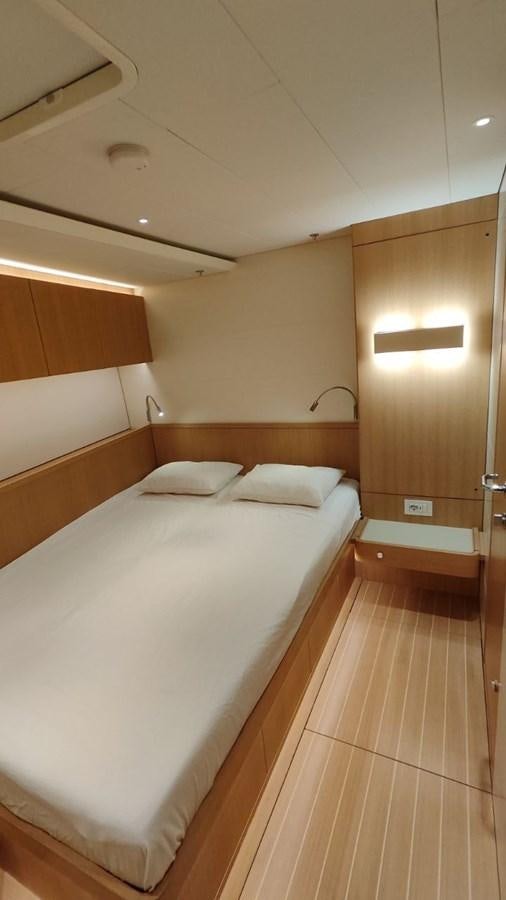 a room with a bed and a wood wall aboard SULITA Yacht for Sale