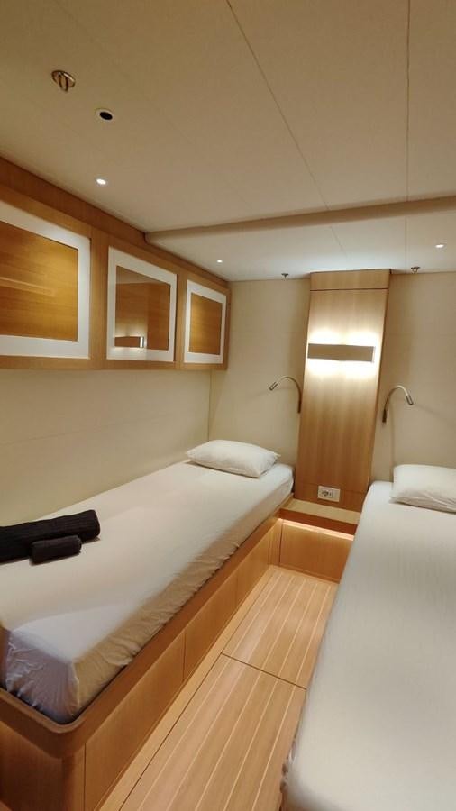 a bedroom with a bed and a window aboard SULITA Yacht for Sale