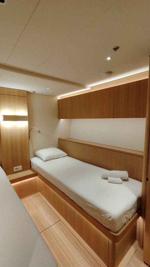 a room with a bed and a lamp aboard SULITA Yacht for Sale