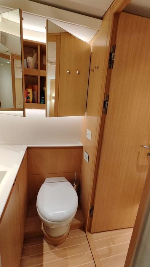 a bathroom with a toilet and a mirror aboard SULITA Yacht for Sale