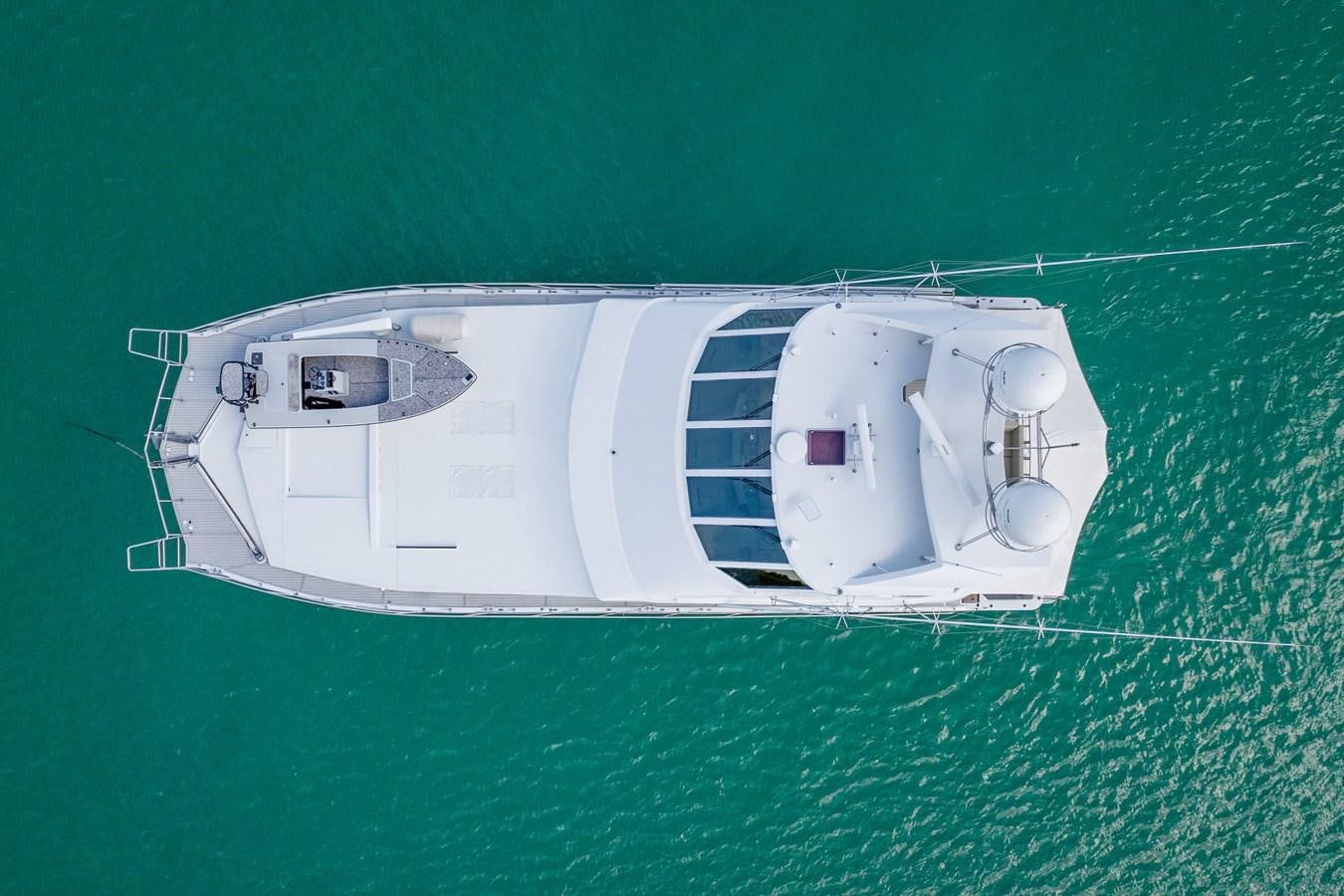 a white boat on a green surface aboard GATO BLANCO Yacht for Sale