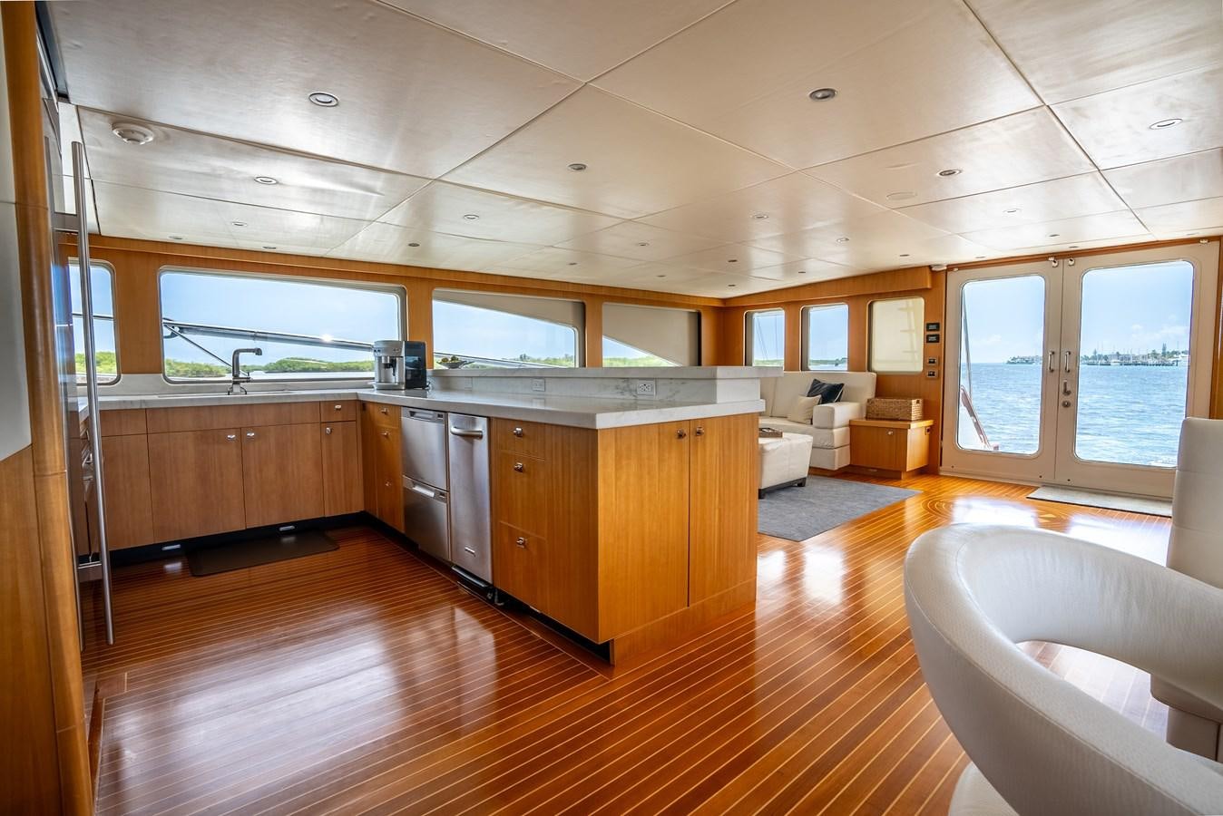 a large kitchen with wooden cabinets aboard GATO BLANCO Yacht for Sale
