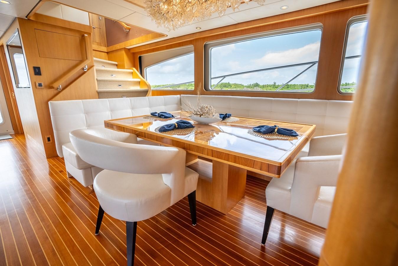 a kitchen with a table and chairs aboard GATO BLANCO Yacht for Sale