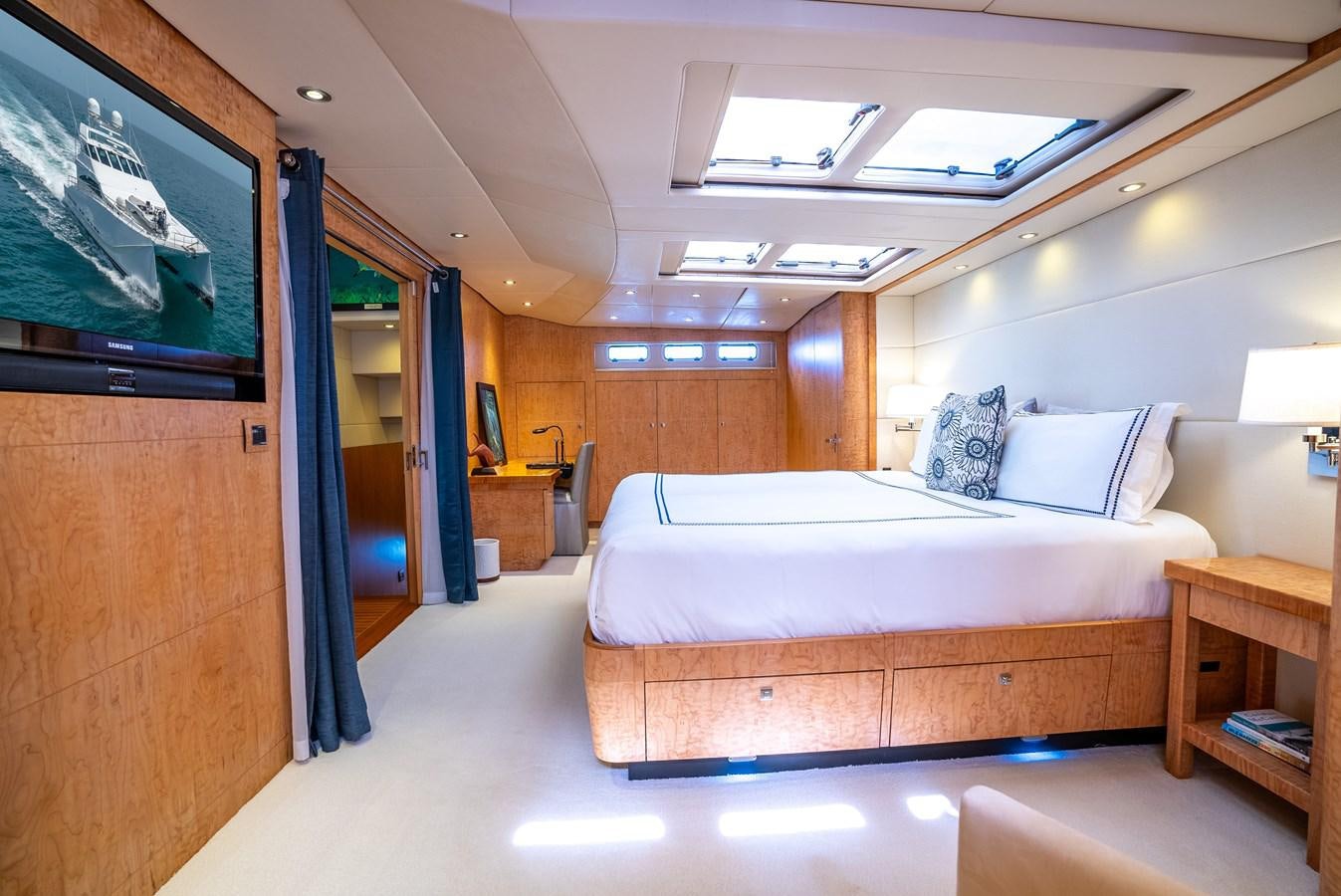 a room with a bed and a television aboard GATO BLANCO Yacht for Sale