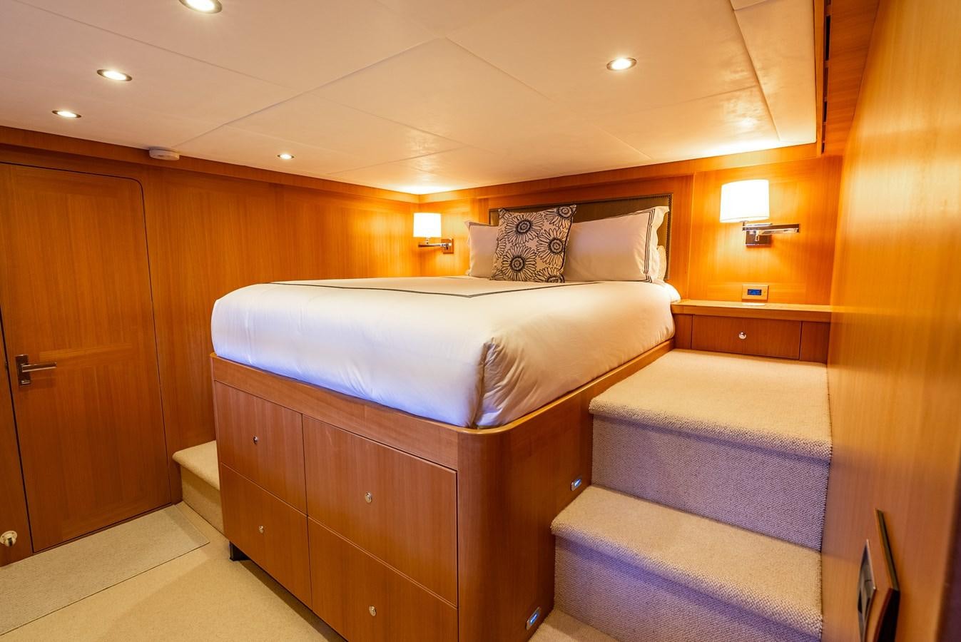 a bedroom with a bed and a desk aboard GATO BLANCO Yacht for Sale