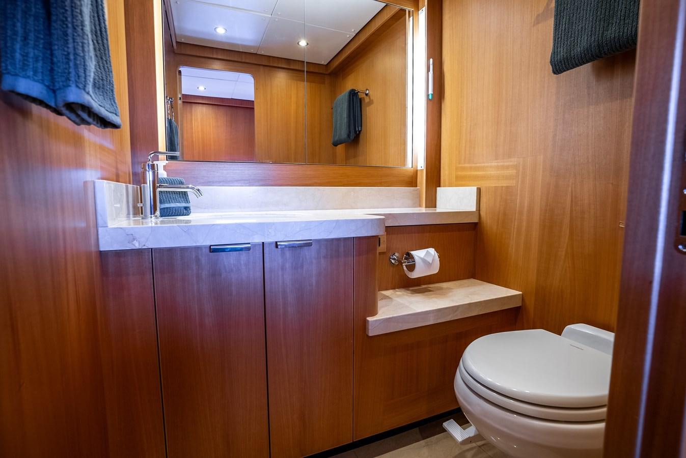 a bathroom with wooden cabinets aboard GATO BLANCO Yacht for Sale