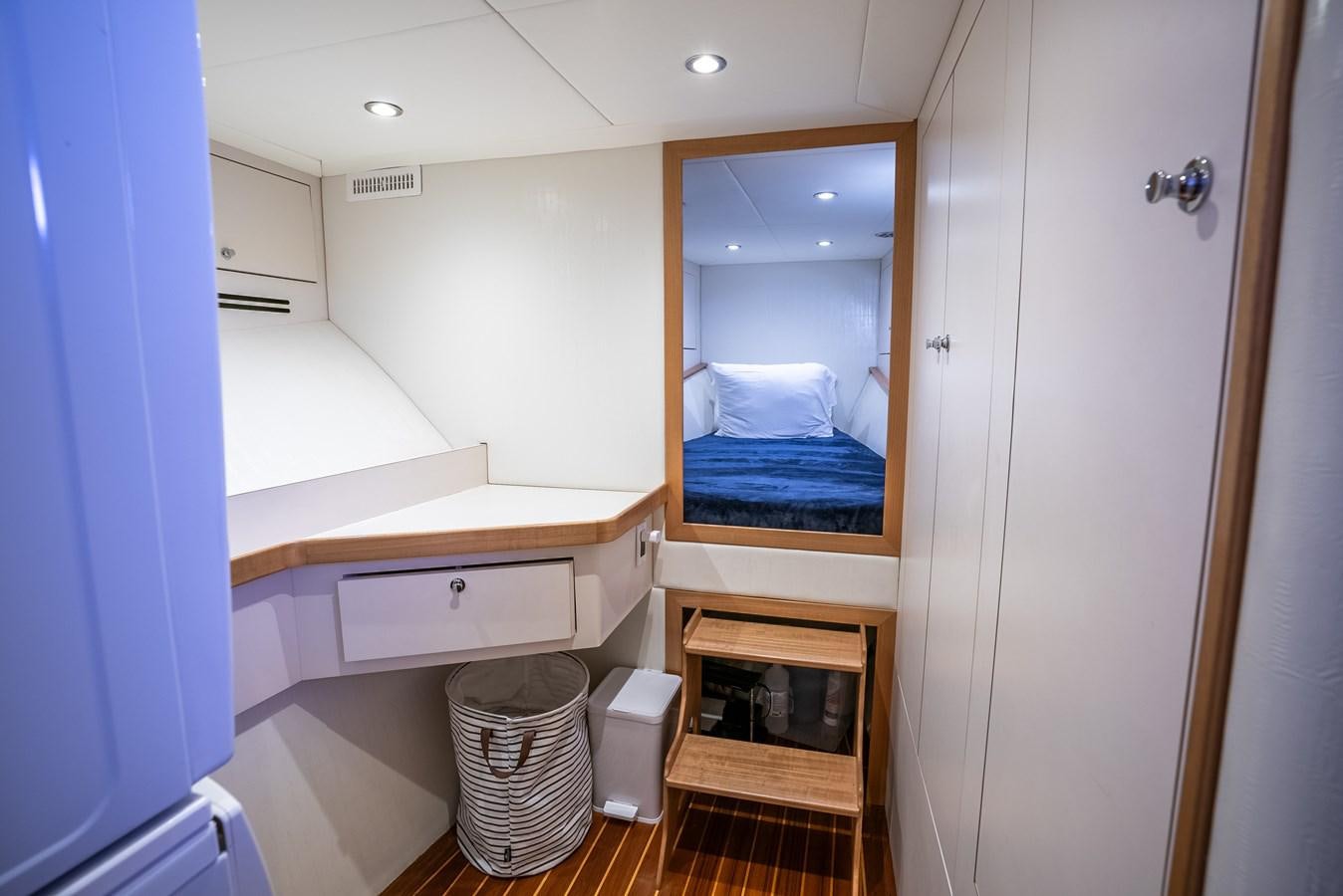 a bathroom with a bed and a sink aboard GATO BLANCO Yacht for Sale