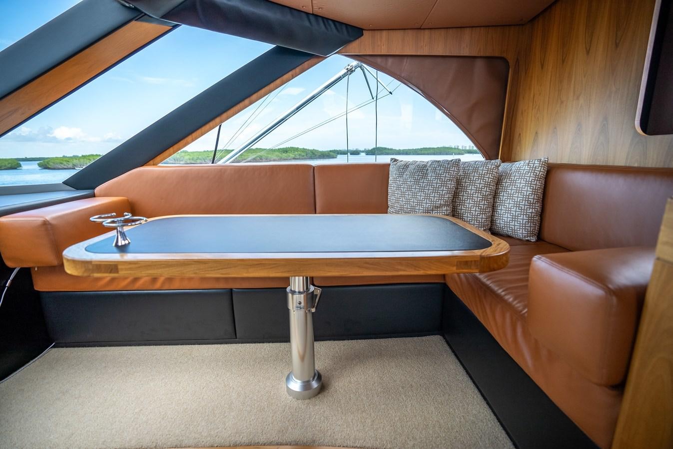 a table with a couch and a pool table aboard GATO BLANCO Yacht for Sale