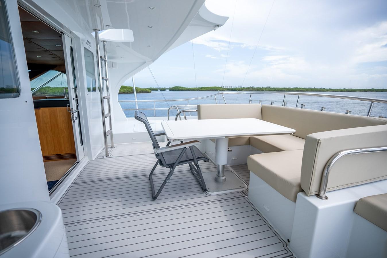 a room with a table and chairs aboard GATO BLANCO Yacht for Sale