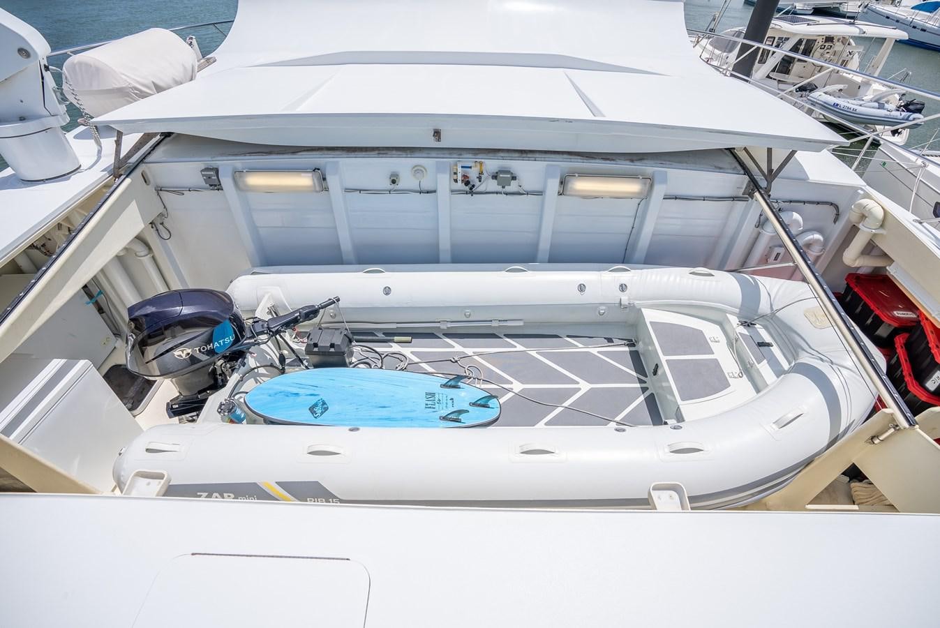 a white boat with a blue canopy aboard GATO BLANCO Yacht for Sale