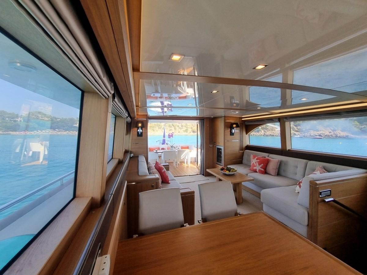 a living room with a large window aboard PLEIADES Yacht for Sale