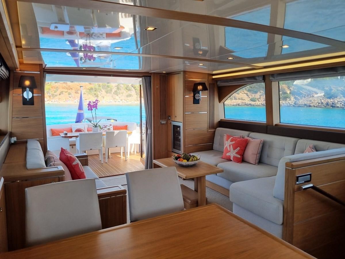 a living room with a large window aboard PLEIADES Yacht for Sale
