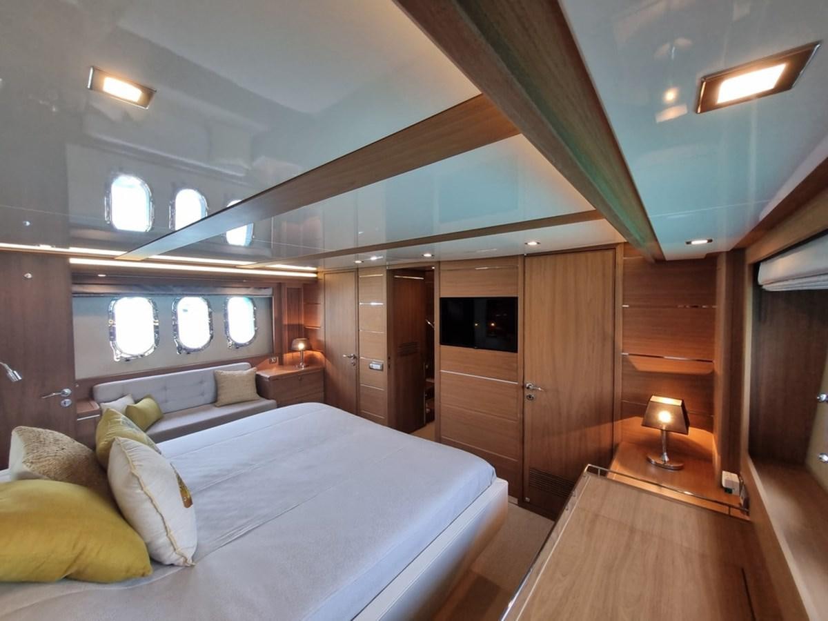 a bedroom with a bed and a desk aboard PLEIADES Yacht for Sale