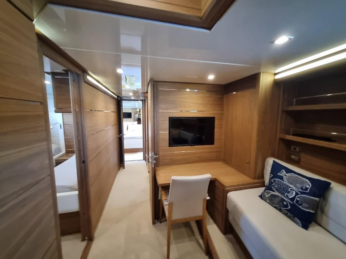 a room with a table and a tv aboard PLEIADES Yacht for Sale