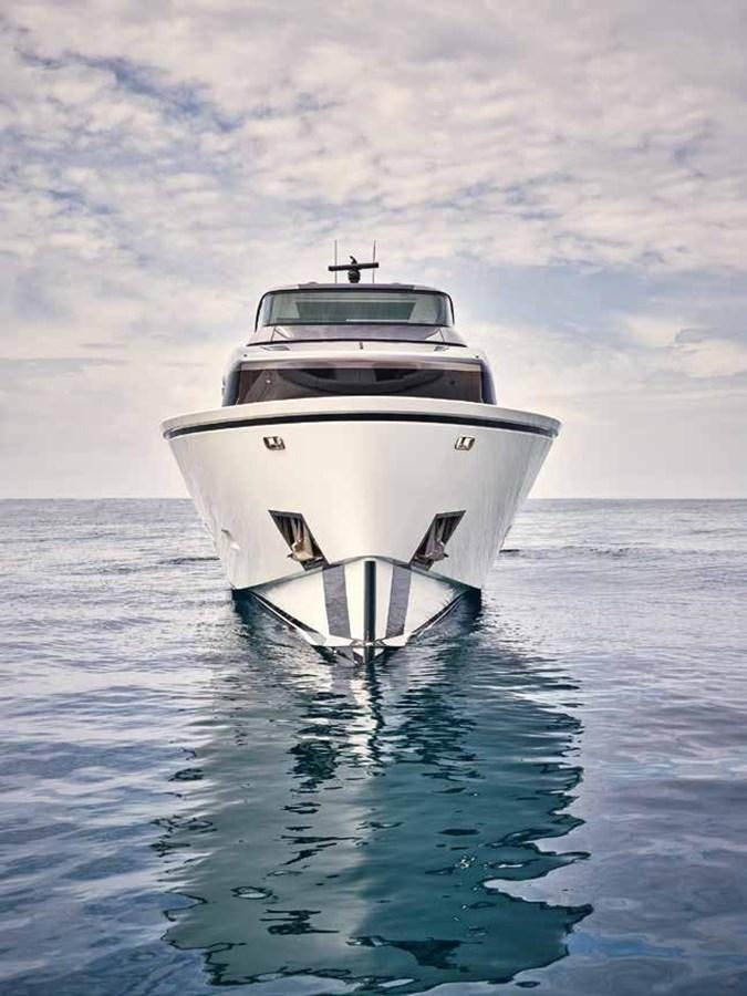 a white boat in the water aboard OMNIA Yacht for Sale