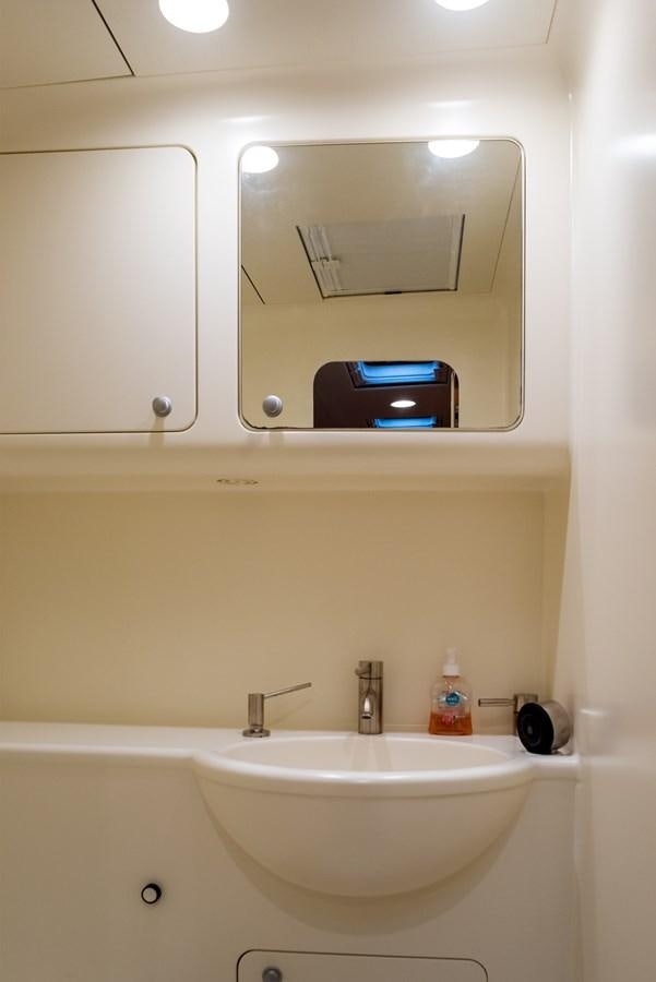 a bathroom with a sink and a tv aboard MISTER A Yacht for Sale