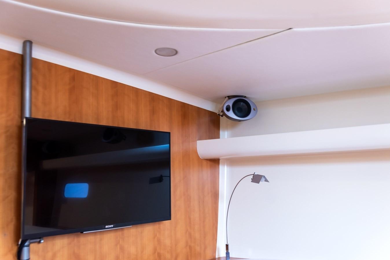 a black television on a wooden cabinet aboard MISTER A Yacht for Sale