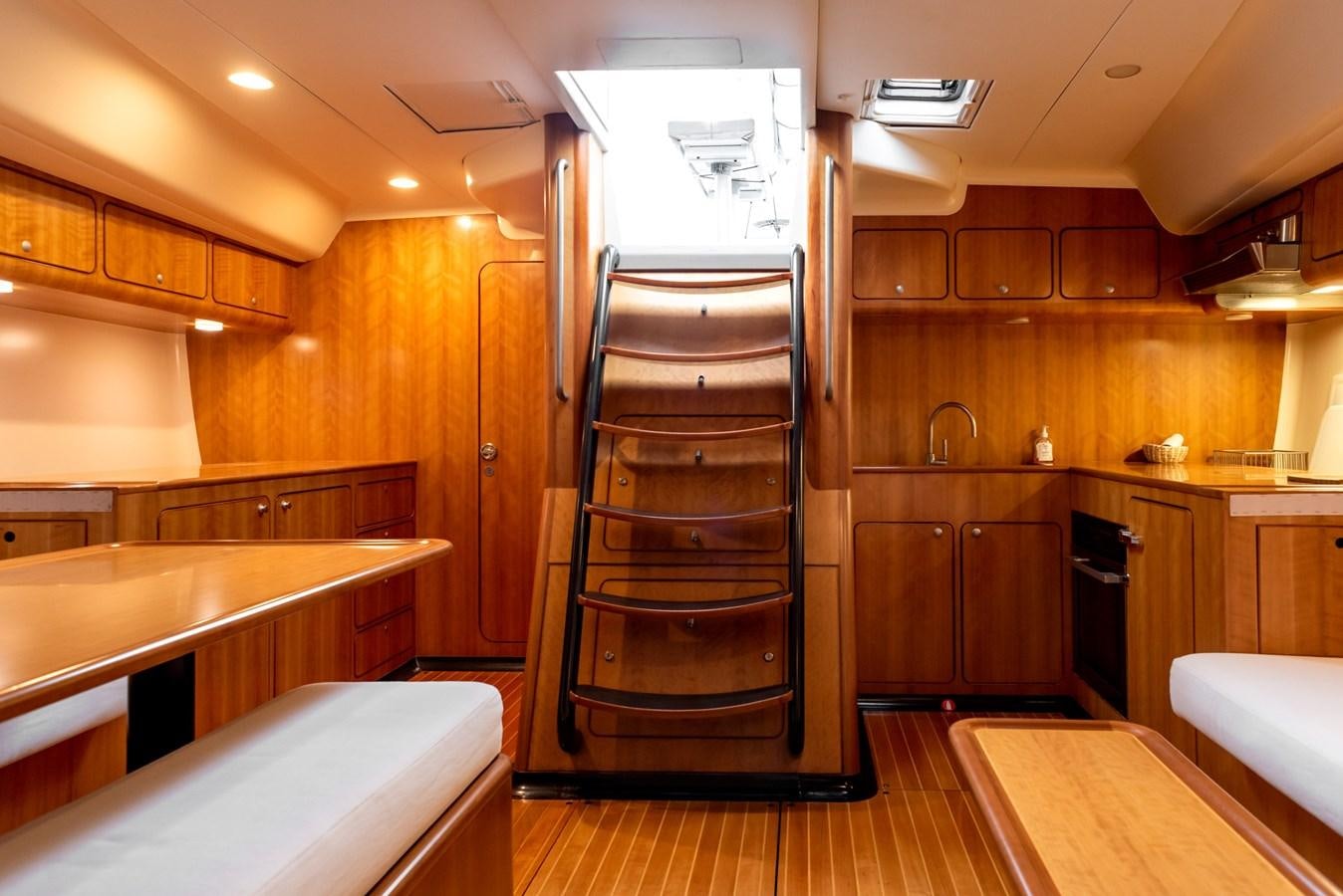 a room with wooden cabinets and a bed aboard MISTER A Yacht for Sale